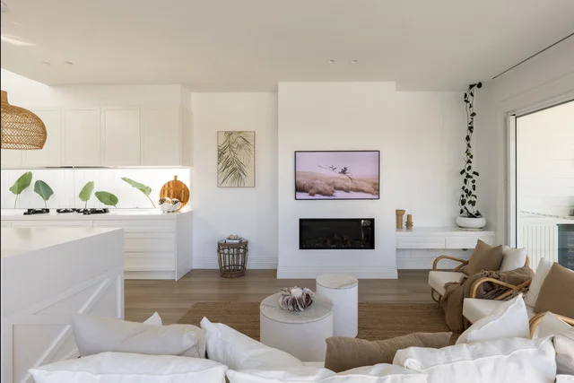 Coastal living room with light oak laminate flooring and white interior design